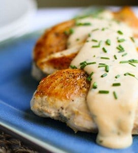 Chicken with Feta Cheese Sauce on a blue plate.