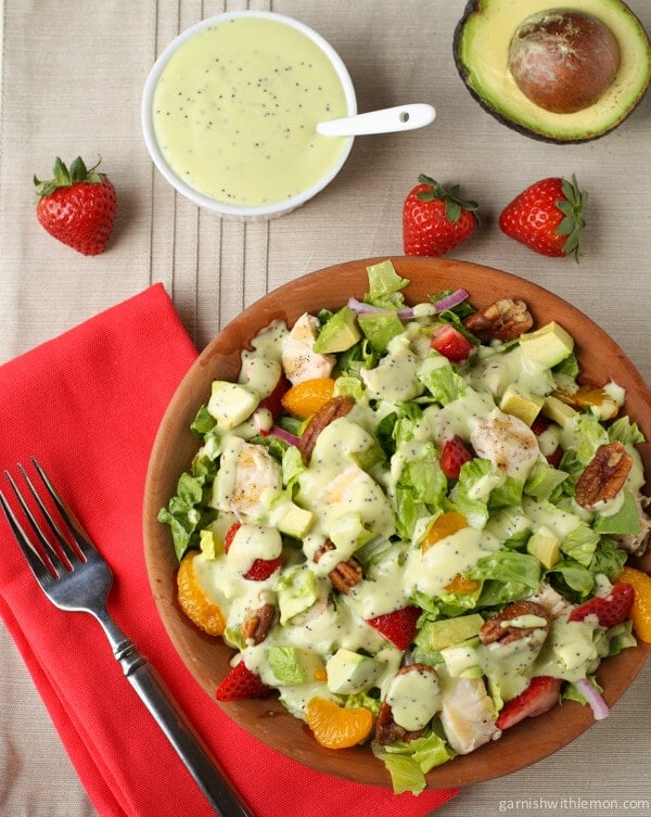 Chicken Strawberry Salad with Avocado Poppy Seed Dressing on a plate with strawberries.