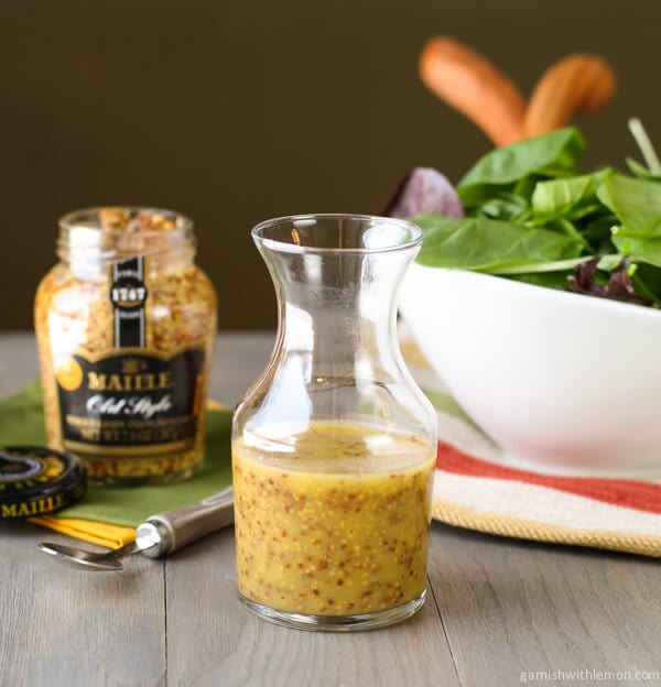 Dijon Vinaigrette  in glass jar with salad.