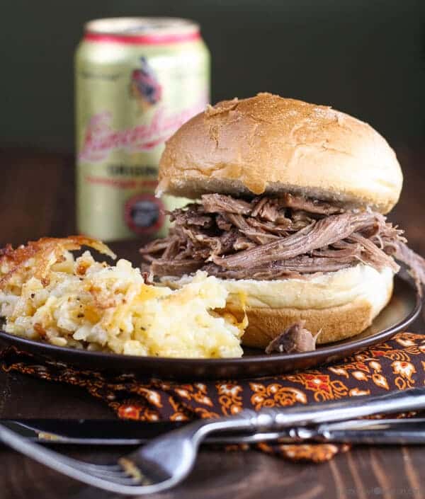 Easy Pulled Beef Sandwiches with potatoes on a plate.