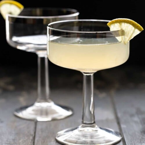 Ginger pear martini in a martini glass with lemon garnish.