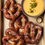 pretzels and cheese dip on tray.