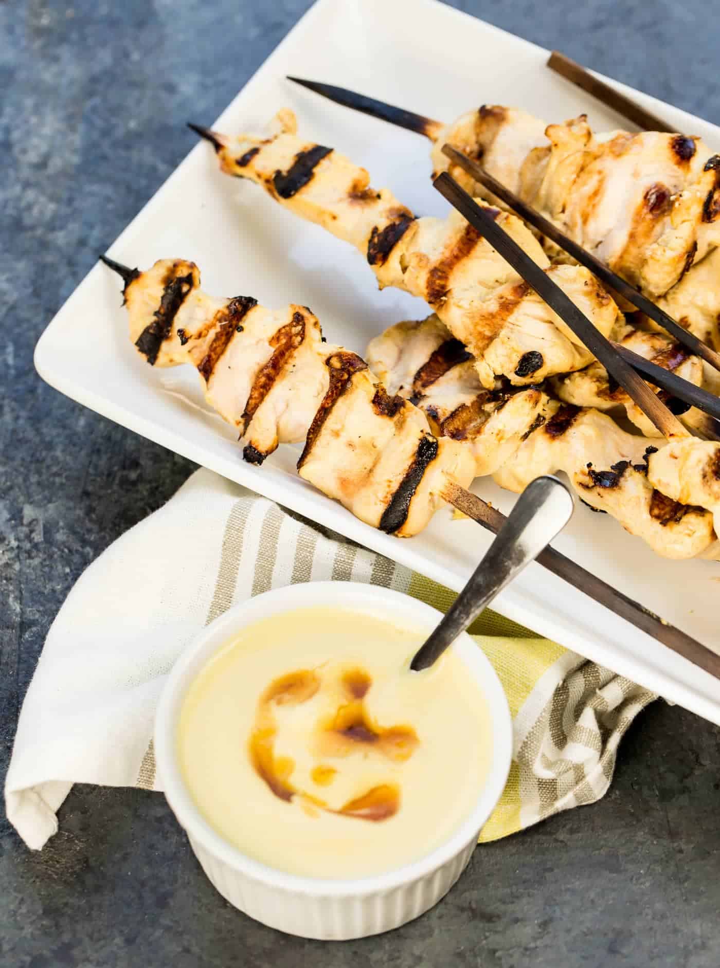 Grilled Chicken and Yogurt skewers on platter with honey mustard.