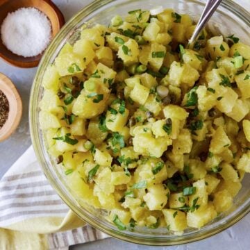 potato salad in bowl with fresh herbs,