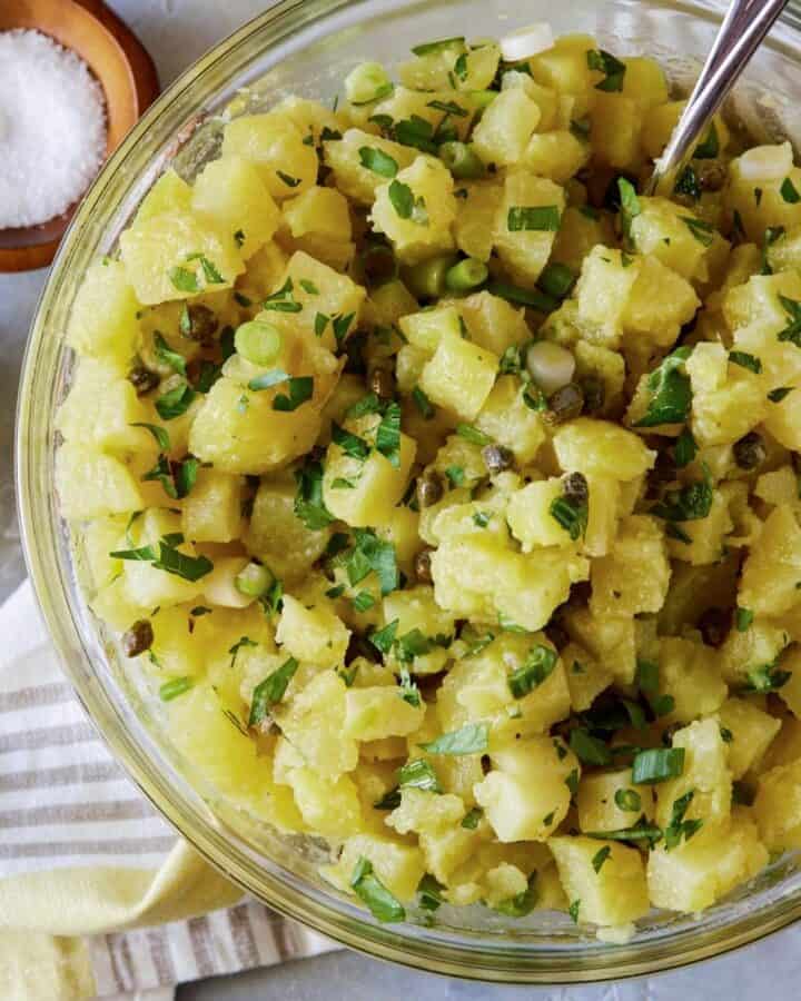 potato salad in bowl with fresh herbs,