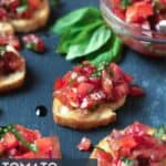 bruschetta with tomatoes and fresh basil on plate.