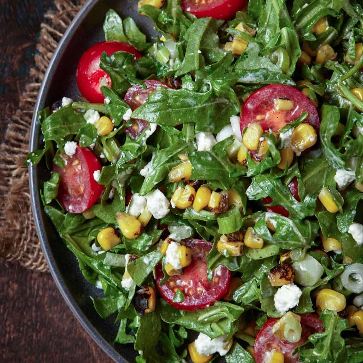 Arugula Corn Goat Cheese Salad Garnish with Lemon