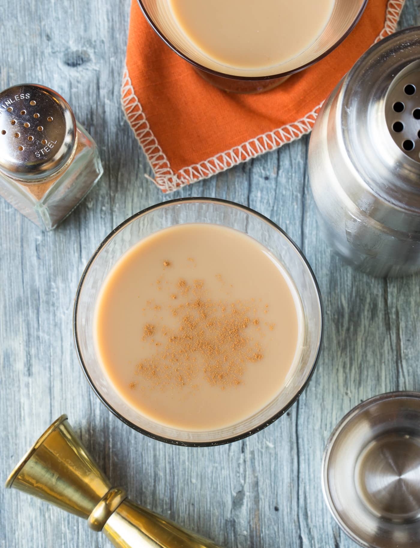 A martini sitting on top of a wooden table, with Pumpkin and Kahlúa.