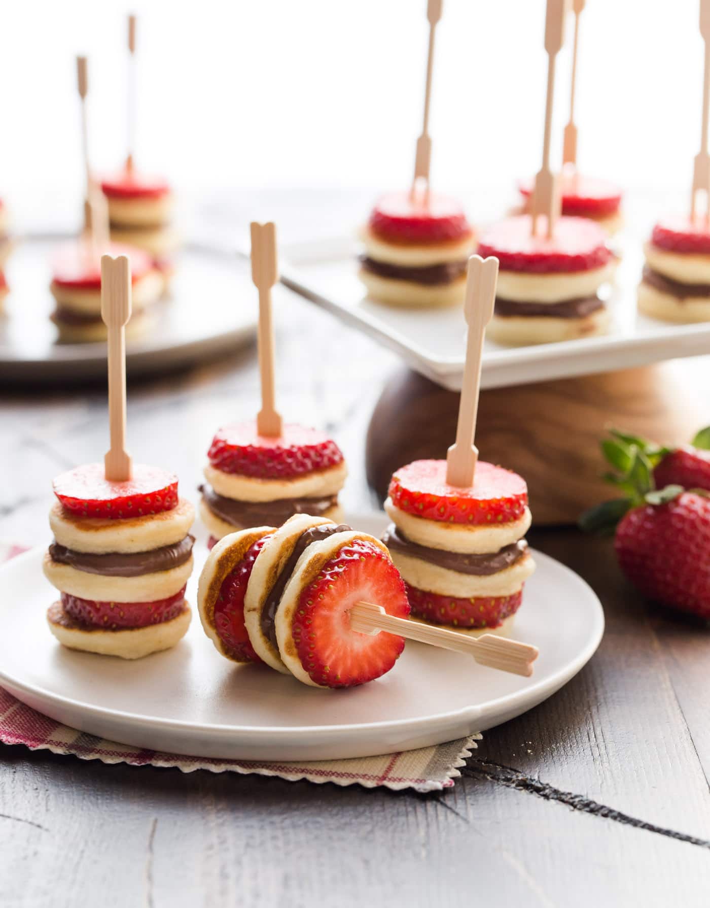 Pancake, strawberries and nutella on skewers.