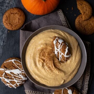 A bowl of pumpkin dip on a table.