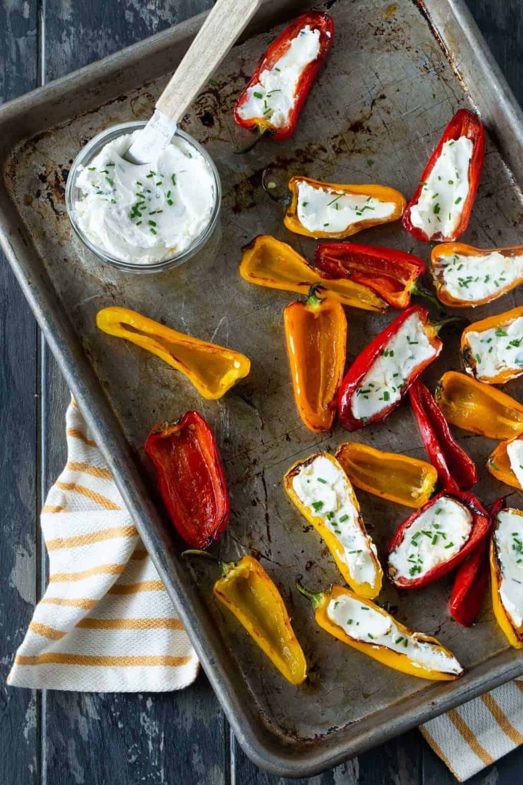 peppers on sheet pan with fresh herbs for garnish.