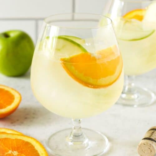 glass filled with lemonade and fruit slices.