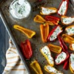 grilled mini peppers on tray stuffed with cream cheese.