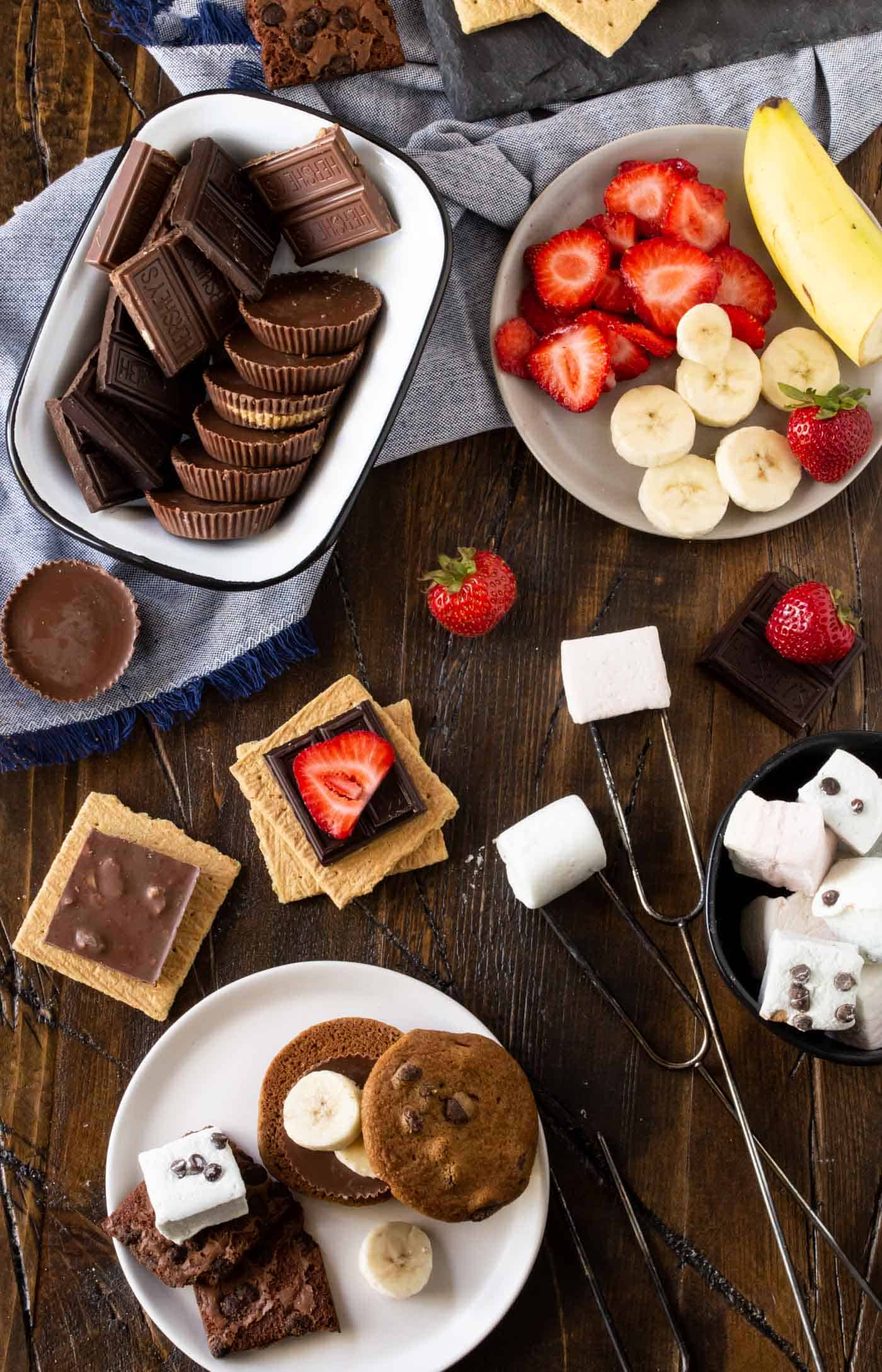 chocolates, marshmallows and graham crackers on a table.