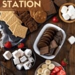 marshmallows, graham crackers, cookies, and fruit on a table.