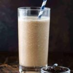 Coffee Smoothie in a high ball glass on a dark background.