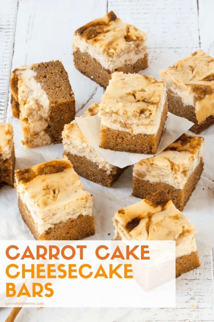 carrot cake cheesecake bars stacked on top of each other on a white background.