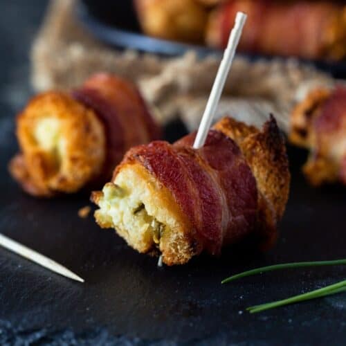 bacon wrapped bites on a plate with toothpick.
