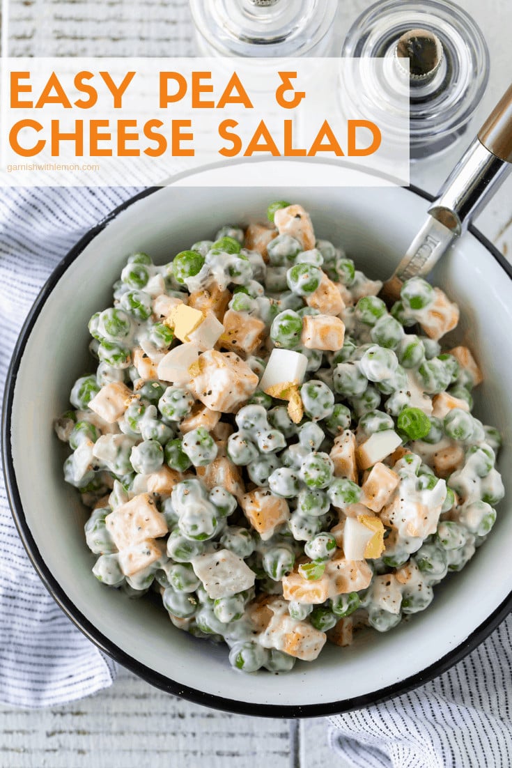 Easy Pea and Cheese Salad in a white bowl with a striped linen and a spoon for serving.