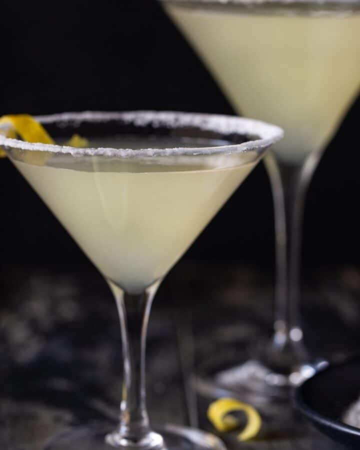 martini glasses on table with lemon peels.