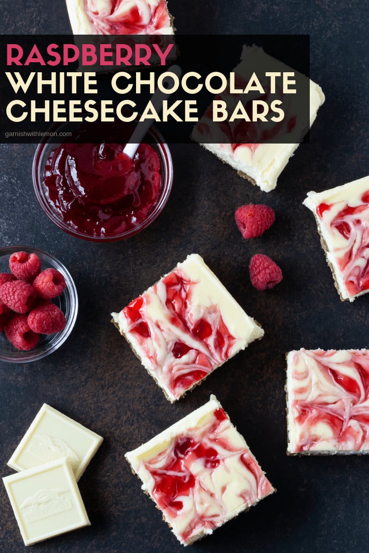  Raspberry White Chocolate Cheesecake bars cut into squares on a dark surface.