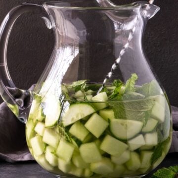 pitcher filled with wine, cucumbers and melon.