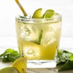 A glass cup on a table, with Lime.