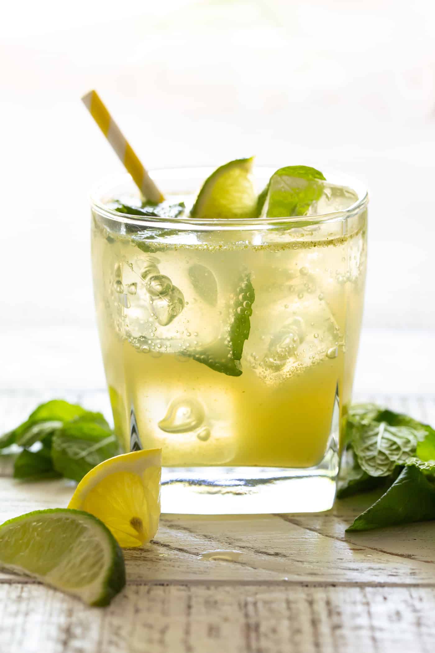 A glass cup on a table, with Lime.