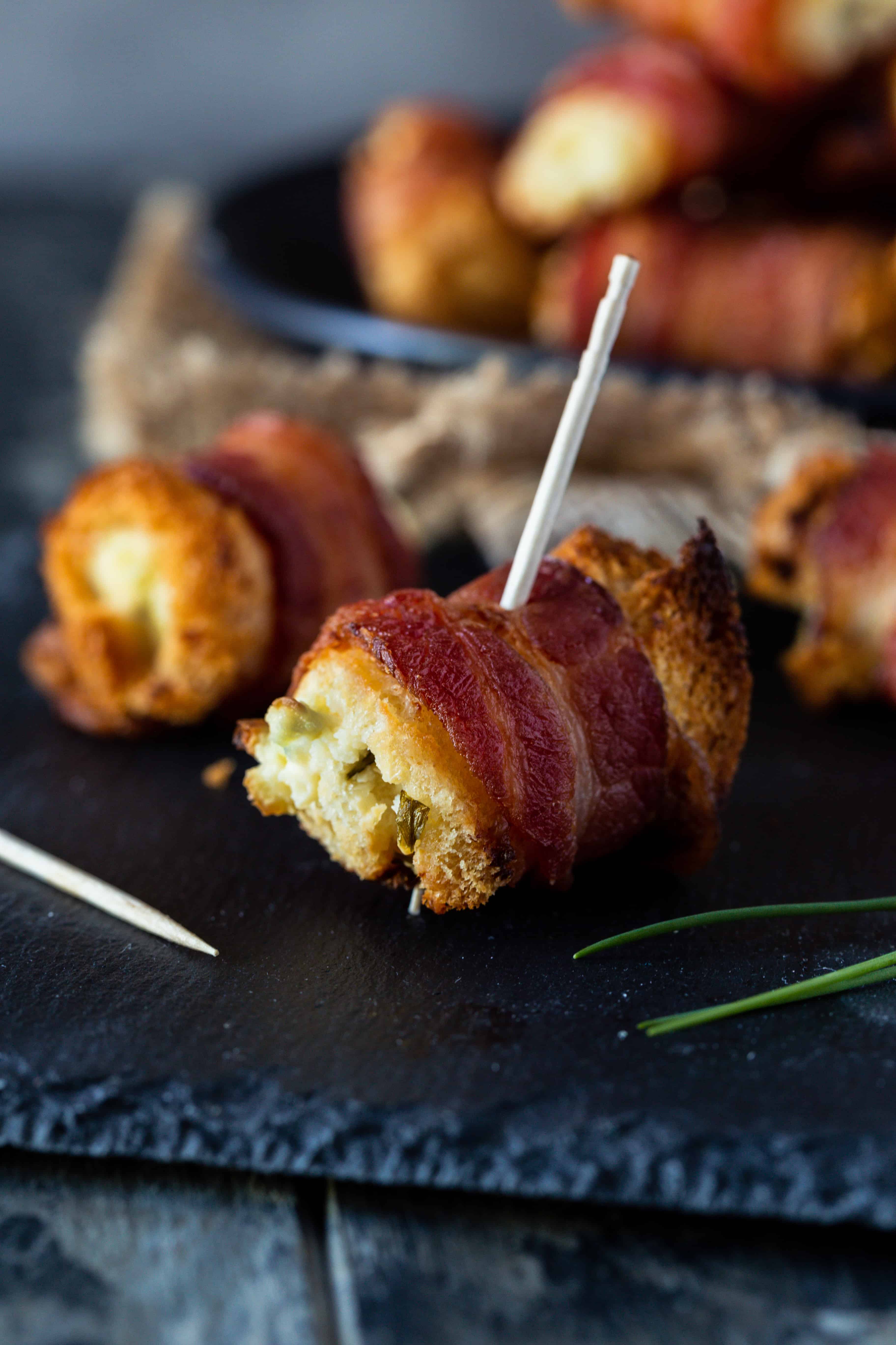 Close up of Bacon cream cheese bites with fresh chives for garnish.