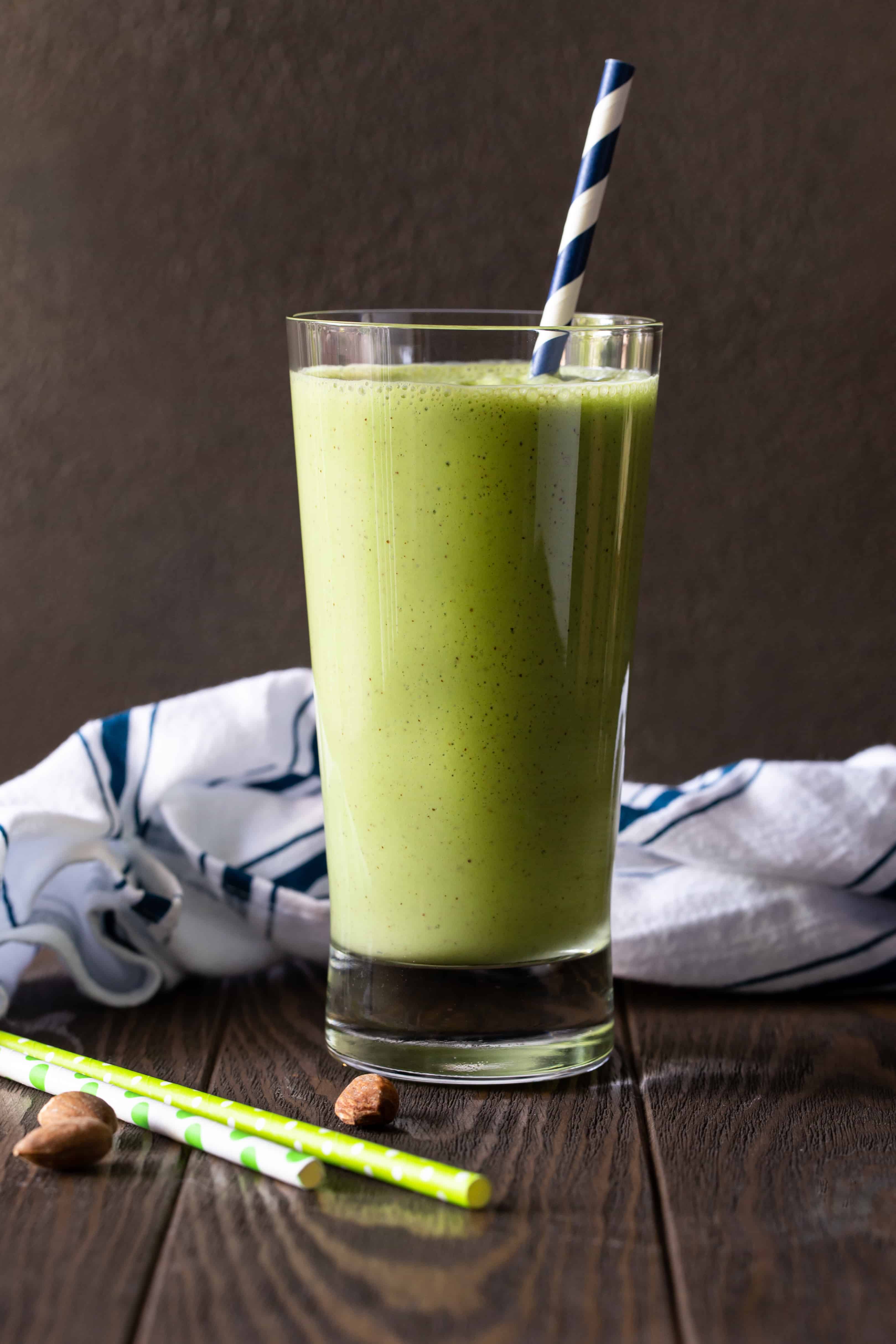 Single glass of blended Smoothie with a blue and white striped straw.