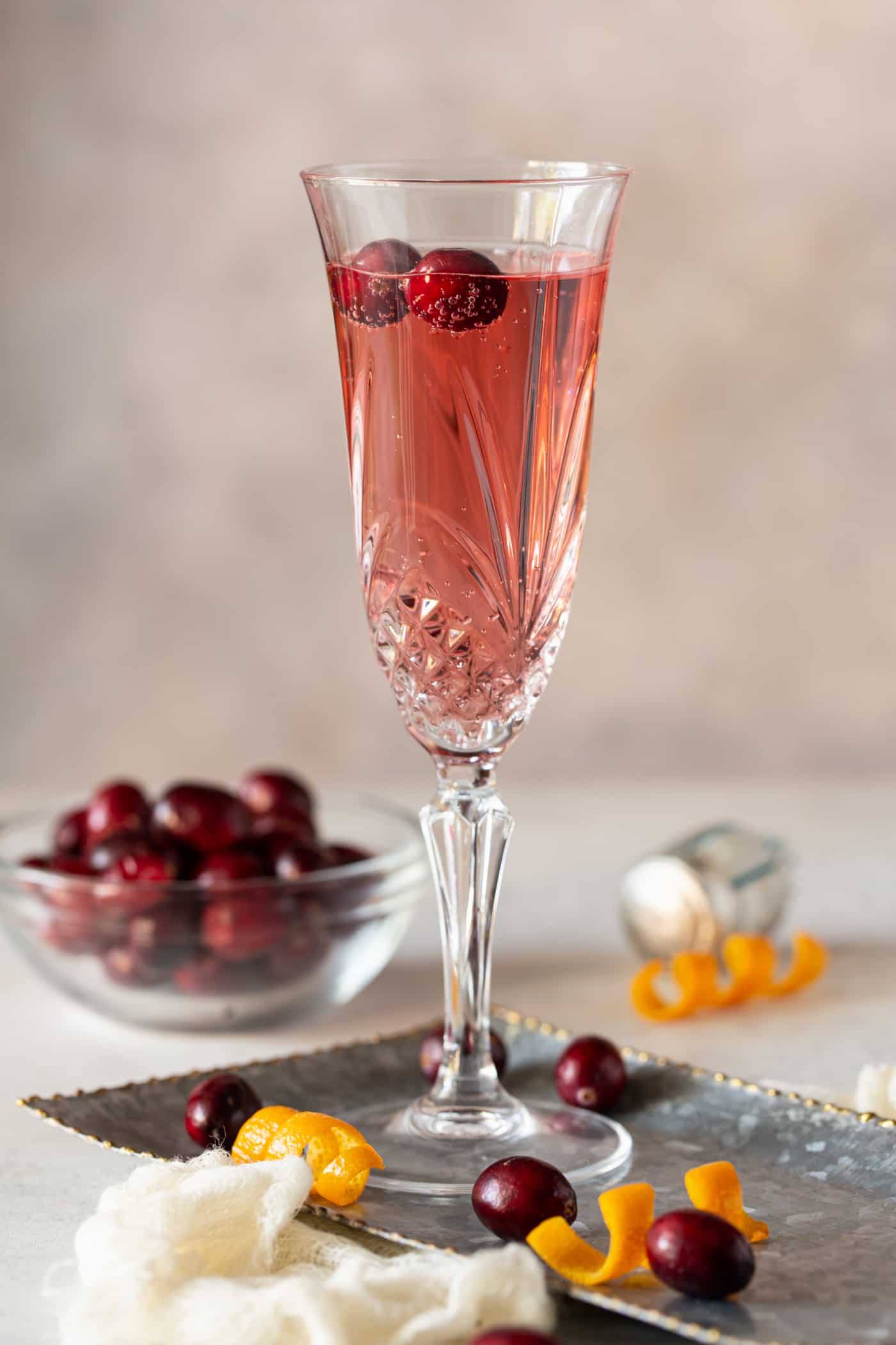 A close up of a wine glass, with Cranberry and Prosecco.