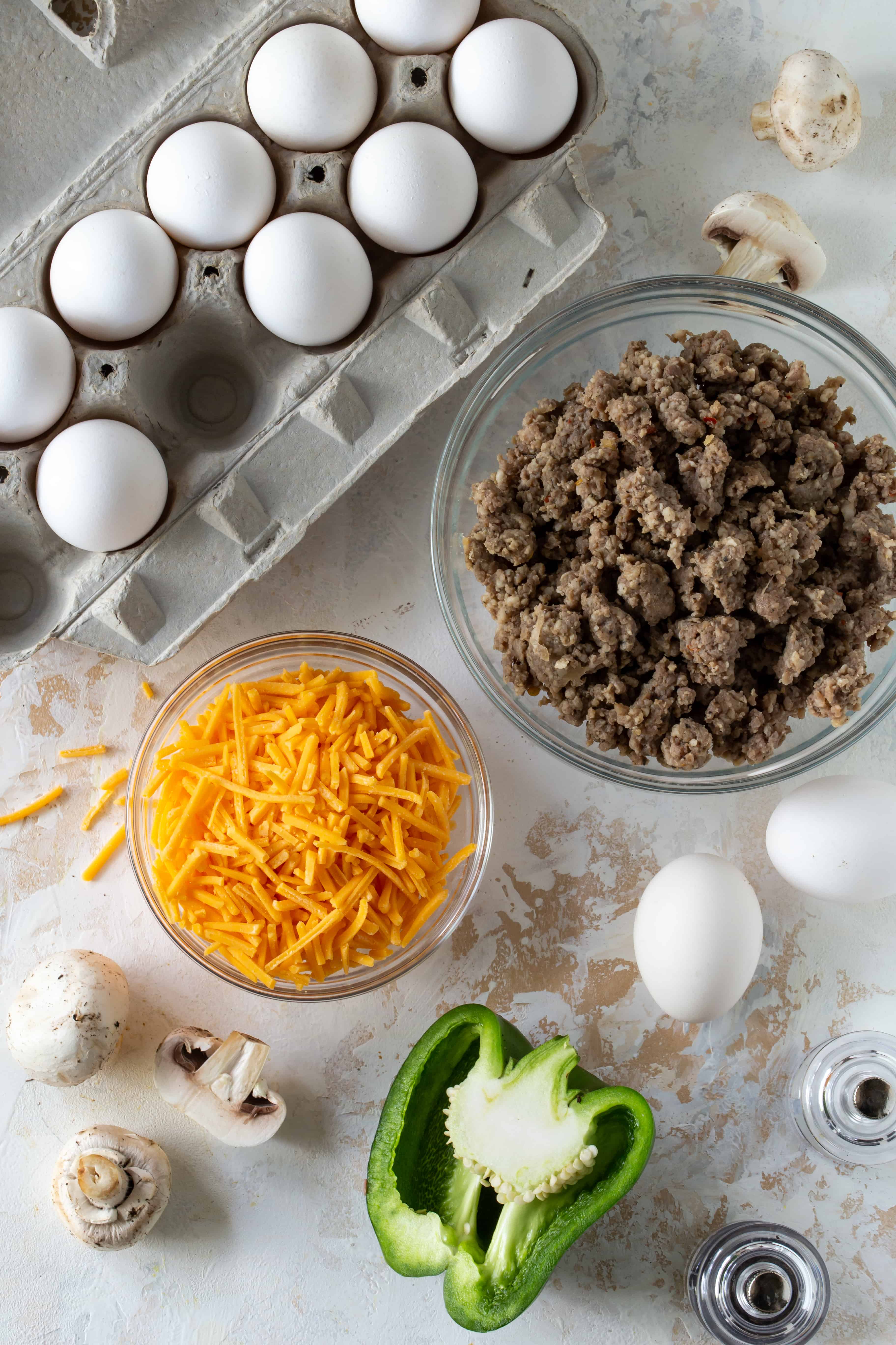 Casserole ingredients including eggs, sausage and cheese