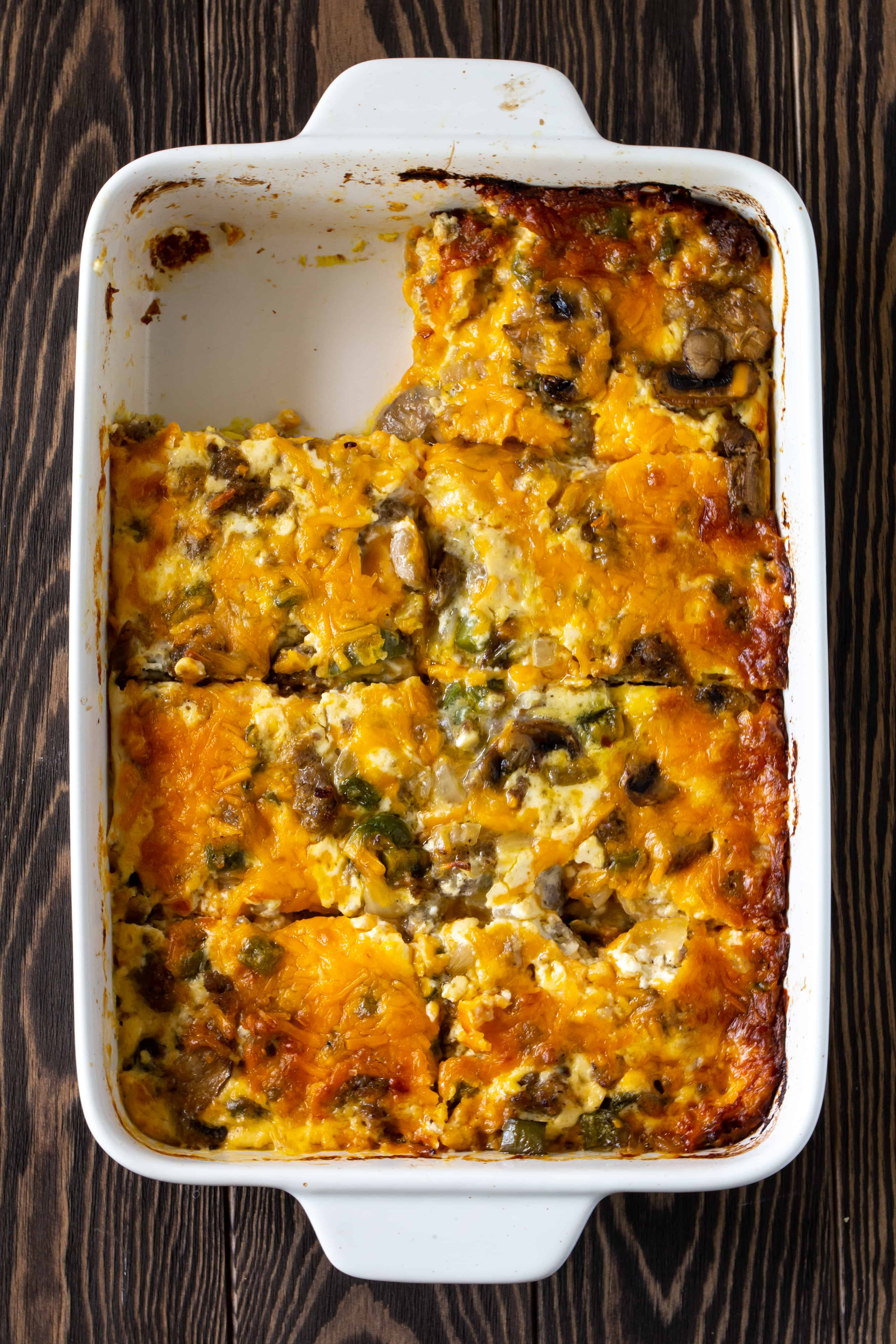 Breakfast Casserole in casserole dish with one piece removed.