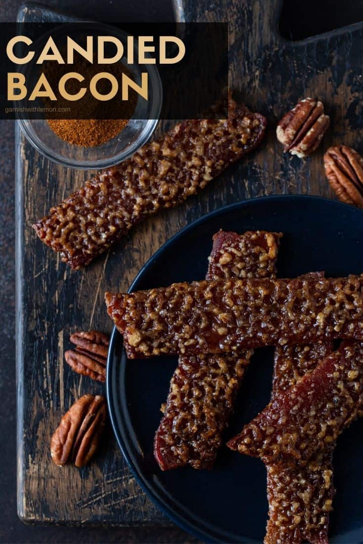 Candied Bacon on a dark plate, with pecans and cayenne pepper.