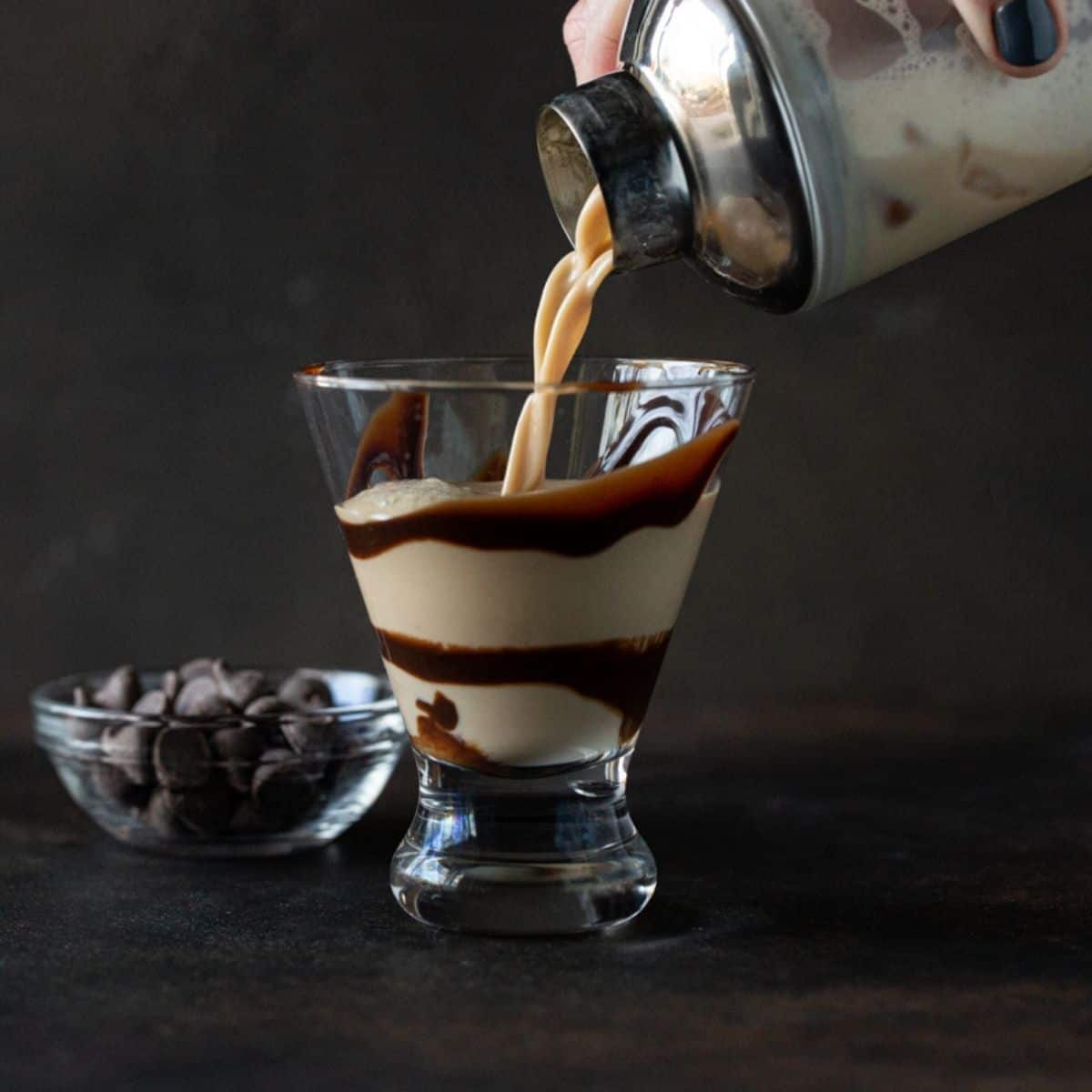 Martini glass filled with chocolate drink and swirl.