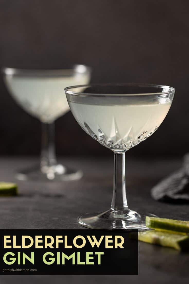 Coupe glasses filled with Elderflower Gin Gimlet Cocktails on a dark board. 