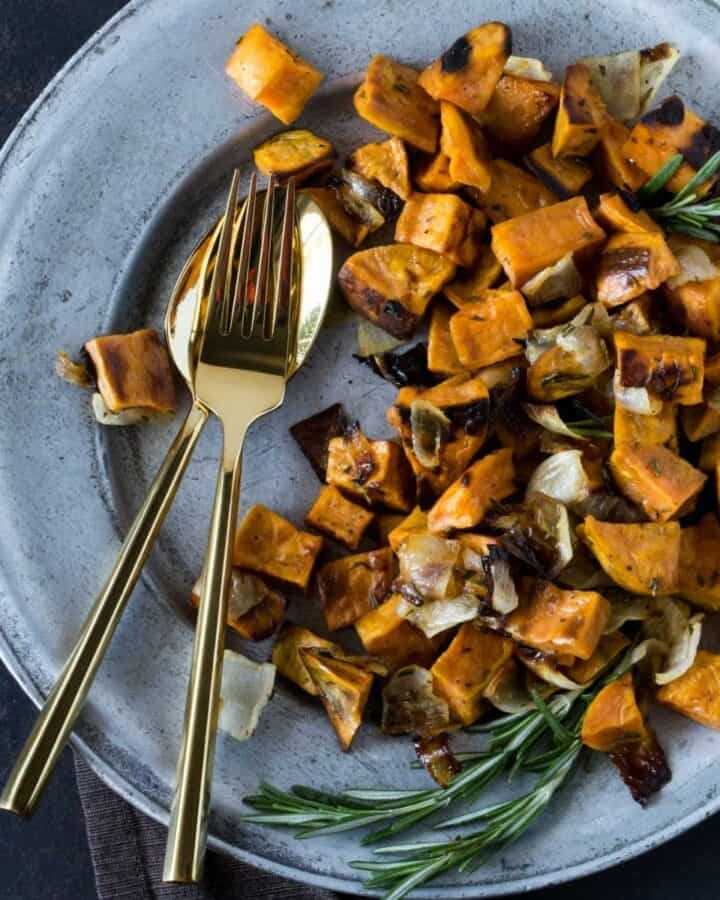 roasted sweet potatoes and onions on plate.