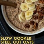 A bowl of Slow Cooker Steel Cut Oats garnished with bananas and pecans in a slow cooker water bath.
