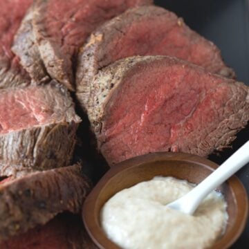 sliced beef on cutting board.