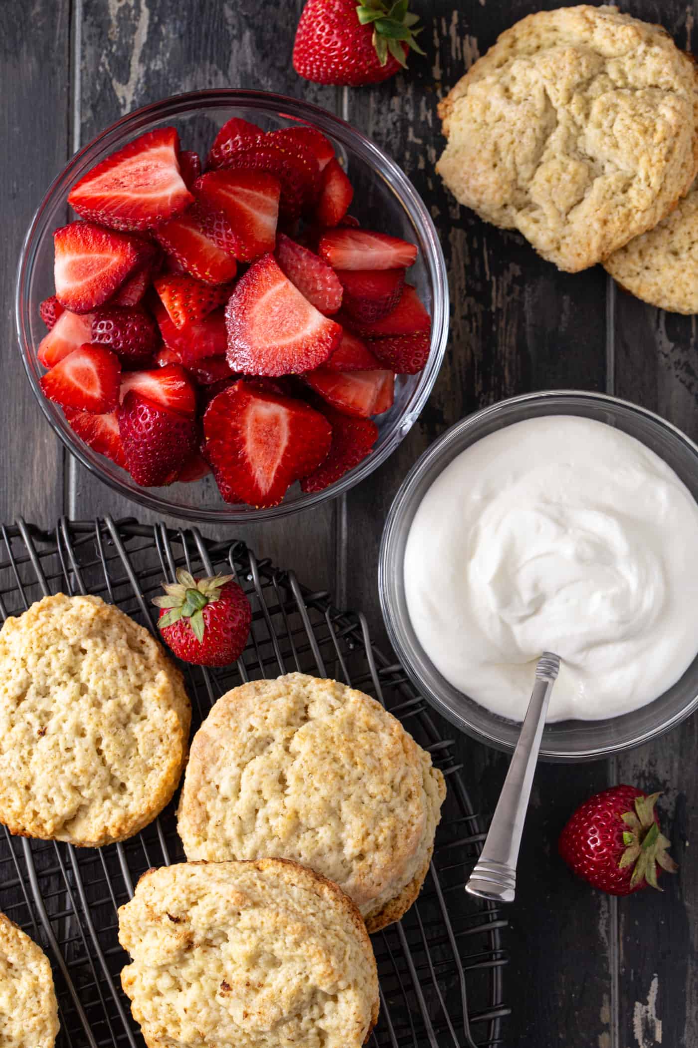 A bowl of fruit, with Strawberry and Cream and shortcakes.