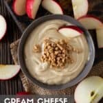 cream cheese apple dip in bowl with sliced apples.