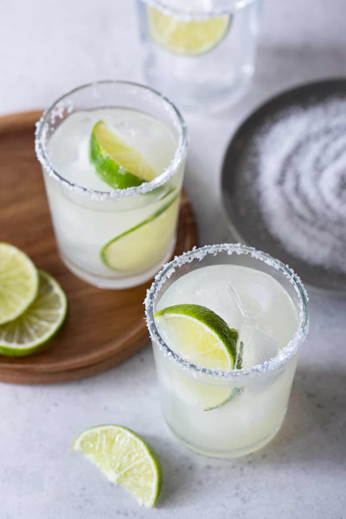 Top down image of salt rimmed glasses filled with margaritas.