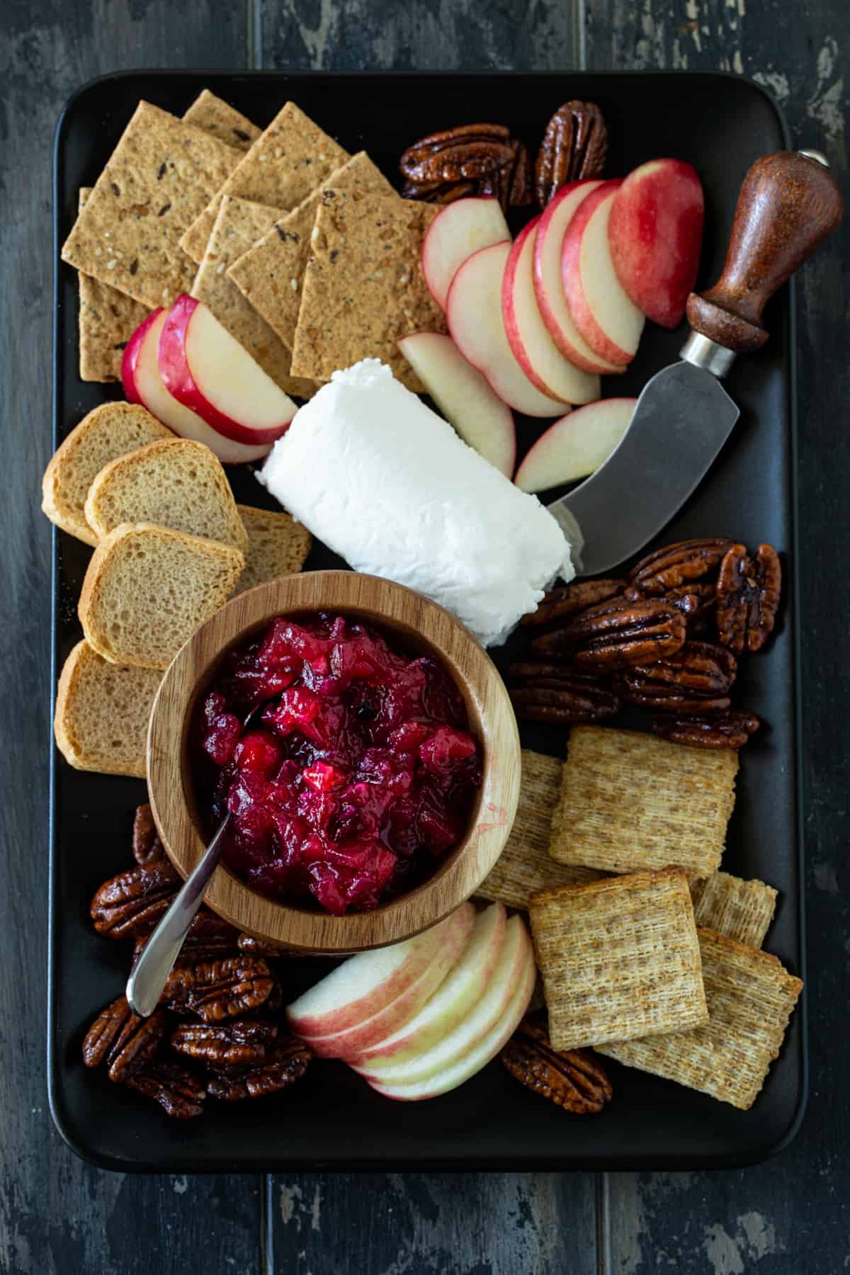 Tray of cheese, crackers, nuts and chutney.