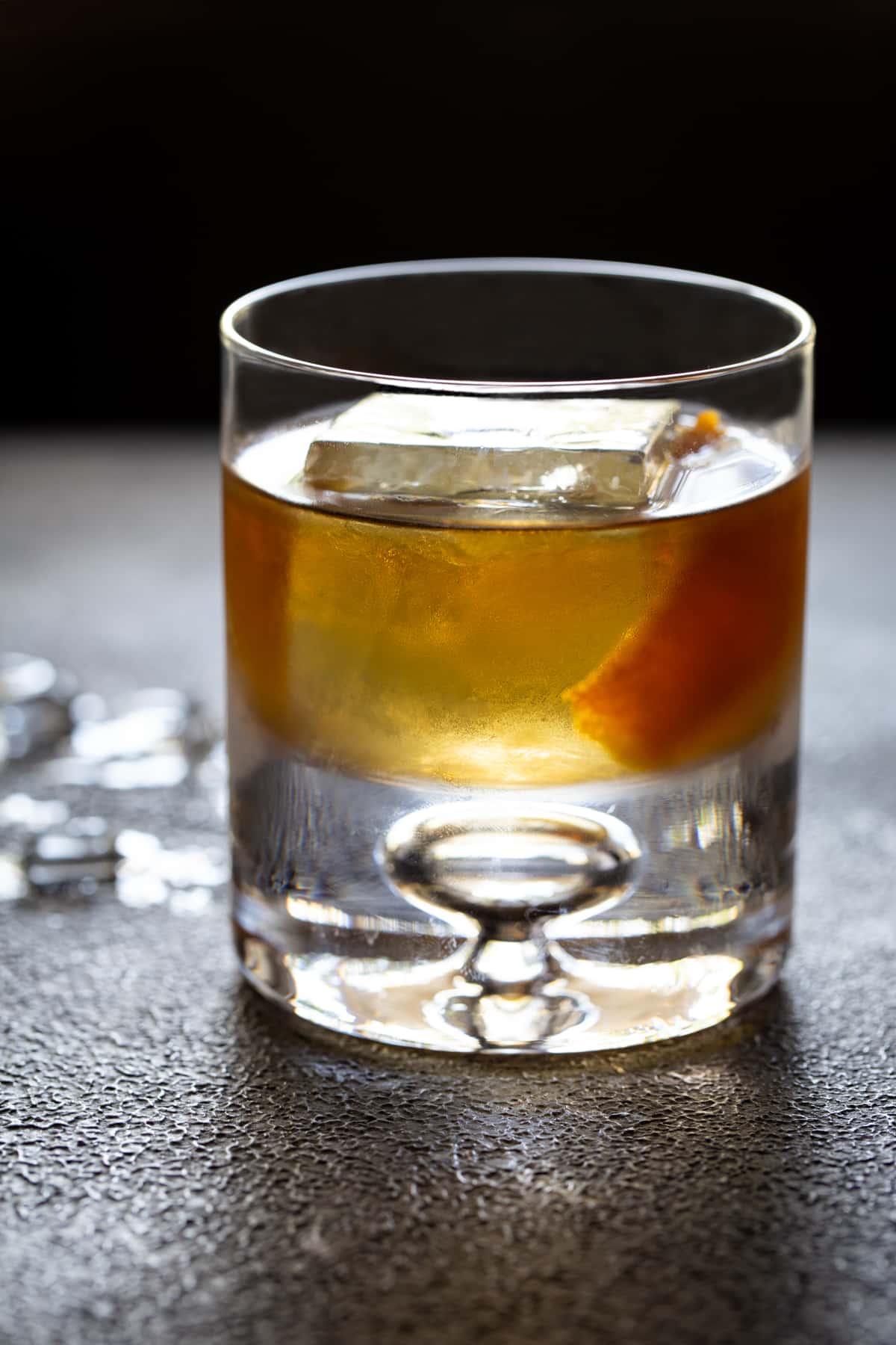 Cocktail in a lowball glass with ice and orange peel