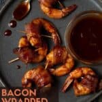 shrimp on a gray plate with barbecue sauce in a small bowl.