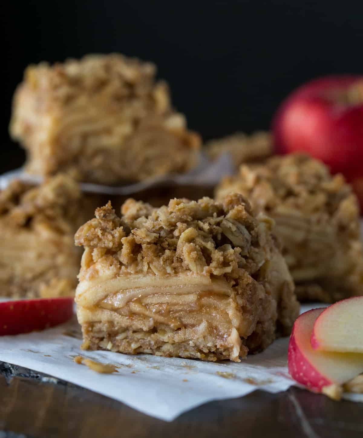 Sliced apple bars on parchment paper.