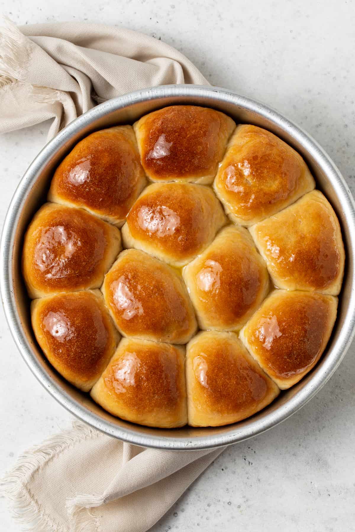 Baked potato rolls in a round cake pan.