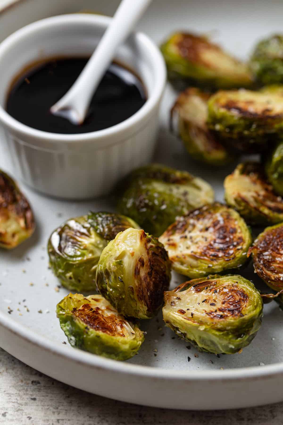 A plate of food with Brussels and Reduction.