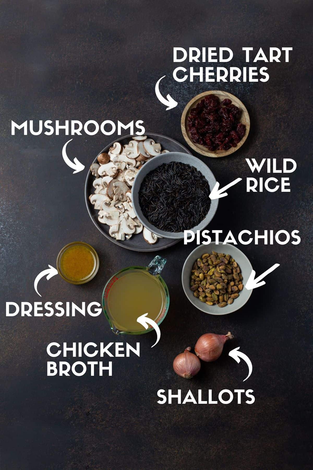 Ingredients for wild rice recipe including wild rice, mushrooms, pistachios, dried cherries, chicken broth, shallots and a maple dijon dressing. 