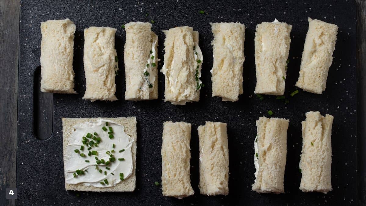 Pieces of bread rolled with cream cheese and chives.